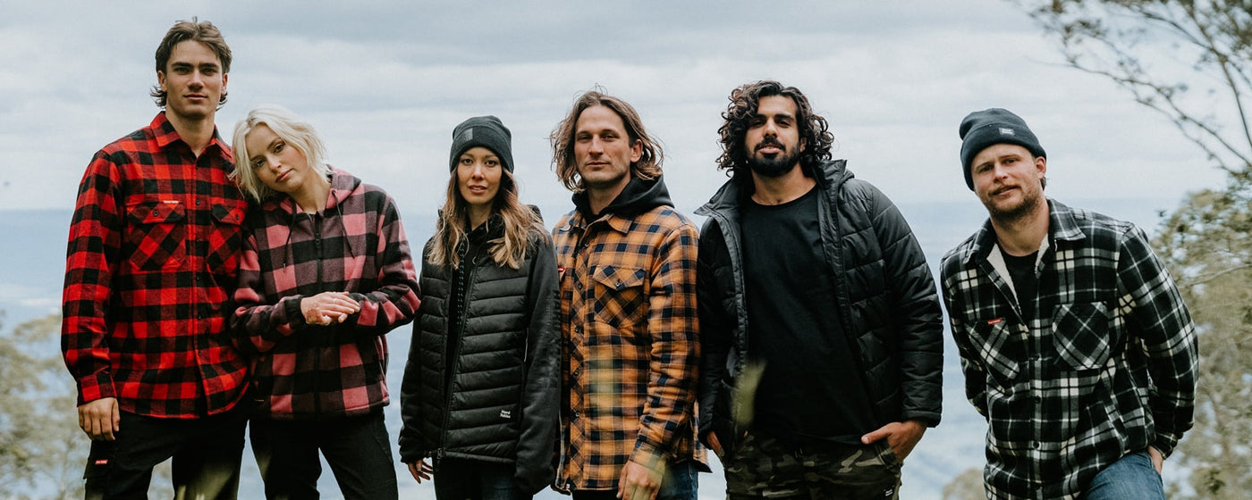 A group of men and women outside wearing Hard Yakka clothing